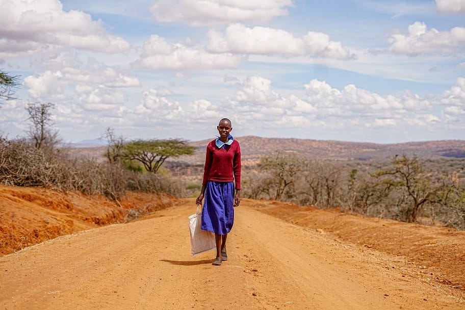 12 year old Christine walks home from School in Kajiado during the 2022 drought. © Billy Miaron