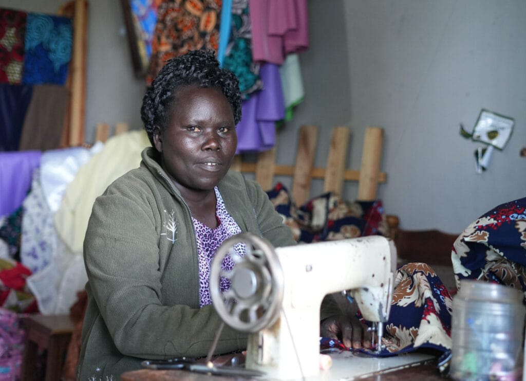 Phillis Kerubu at her tailoring business in Kisii, Kenya which she opened thanks to Kahawa 1893. Photo by Billy Miaron