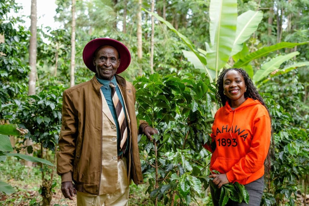 Margaret Nyamumbo, founder of Kahawa 1893 with her Grand Father in his coffee farm in Kisii, Kenya. Photo by Billy Miaron