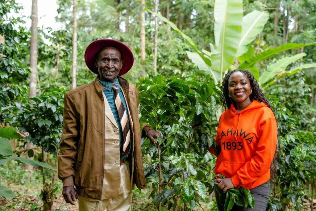 Margaret Nyamumbo, founder of Kahawa 1893 with her Grand Father in his coffee farm in Kisii, Kenya. Photo by Billy Miaron Margaret Nyamumbo, founder of Kahawa 1893 with her Grand Father in his coffee farm in Kisii, Kenya. Photo by Billy Miaron