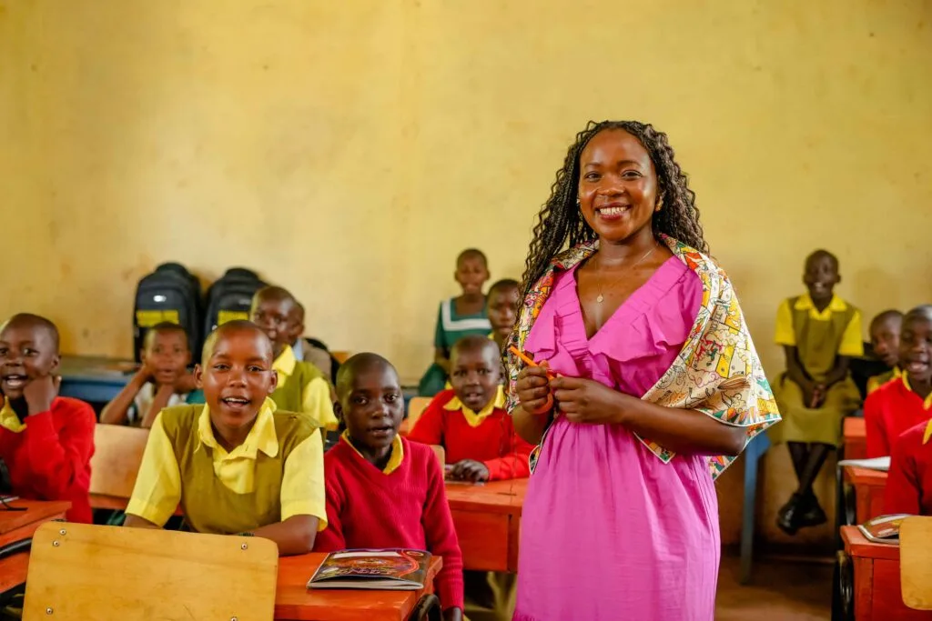 Kahawa 1893 Founder and CEO Margaret Nyamumbo in a classroom with children that her foundation supports. Photo by Billy Miaron. Kahawa 1893 Founder and CEO Margaret Nyamumbo in a classroom with children that her foundation supports. Photo by Billy Miaron.