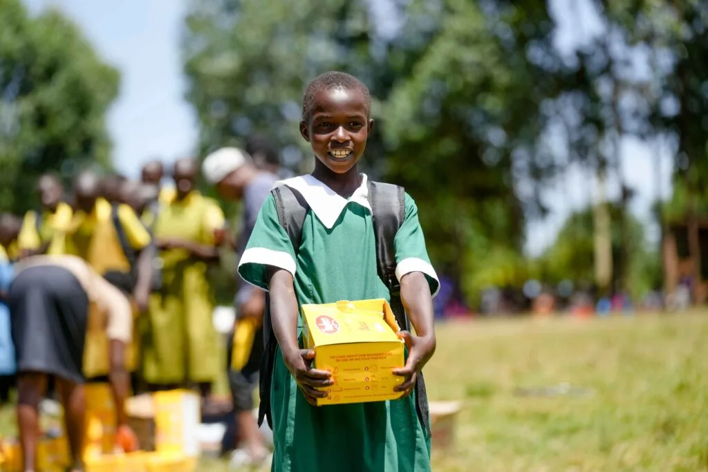 A girl walks to class with a big smile on her face after receiving gifts from Kahawa 893 including a full school uniform and a brand-new pair of shoes. A girl walks to class witha big smile on her face after receiving gifts from Kahawa 893 including full school uniform and a brand new pair of shoes.